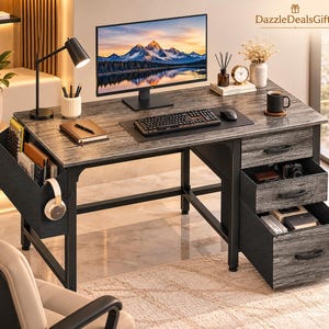 May include: A gray wood-grain desk with a black metal frame, featuring three drawers on the right, a side storage pocket with a hook for headphones, a computer monitor, keyboard, mouse, desk lamp, and office supplies. DazzleDealsGifts logo.