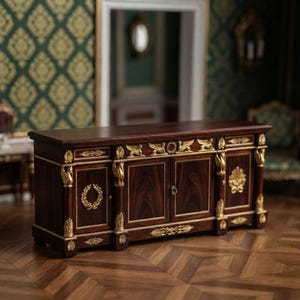 May include: A dark wood sideboard featuring gold-toned metal accents, including winged figures, laurel wreaths, and shell motifs. The rectangular cabinet has four doors with visible wood grain, decorative trim, and a flat top surface.