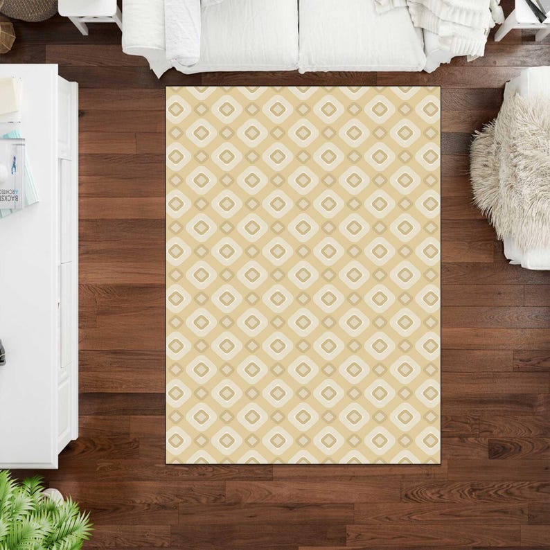 May include: A rectangular area rug featuring a repeating geometric pattern of rounded squares in shades of beige, cream, and light brown. The design consists of concentric square shapes arranged in a grid, creating a soft, neutral aesthetic.
