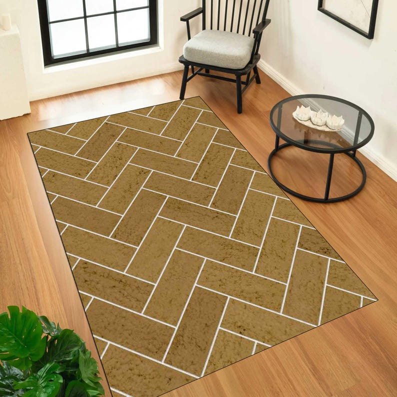May include: A rectangular area rug featuring a repeating herringbone pattern in a textured mustard yellow tone with thin white grout lines between each rectangular segment, creating a visual effect similar to a brick or tile floor layout.