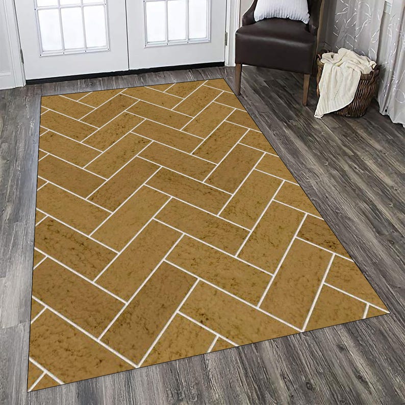 May include: A rectangular area rug featuring a repeating herringbone pattern. The rug consists of rectangular blocks in a textured mustard yellow colour, separated by thin white lines that create a grid-like visual effect across the surface.