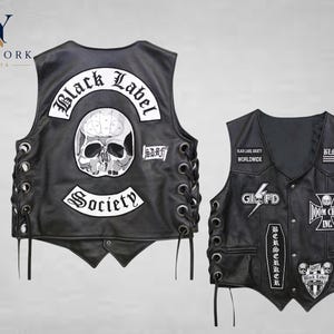 May include: Two black leather vests with skull and crossbones patches. One vest features "Black Label Society" and "Society" patches. The other vest has "Doom Crew Inc" and "Berserker" patches. Both vests have lace-up sides.