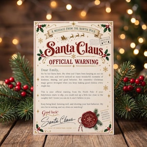 May include: A cream-coloured letter titled A Message From The North Pole Santa Claus Official Warning addressed to Emily. The text encourages good behaviour and kindness, featuring a red wax seal, holly illustrations, and a Santa Claus signature.