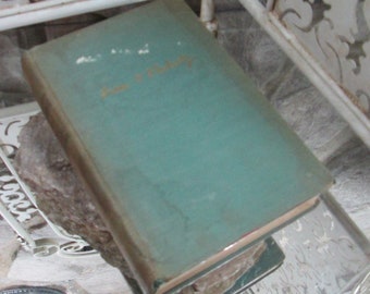 Op de afbeelding: Een teal-kleurig hardback boek met de titel "Jane Eyre" in gouden letters op de voorkant.