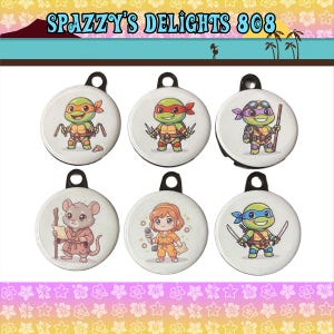 May include: Six circular white plastic keychains featuring cartoon illustrations of four turtles with colored masks and weapons, a mouse in a robe holding a staff, and a person in an orange jumpsuit holding a microphone. Text reads SPAZZY'S DELIGHTS 808.