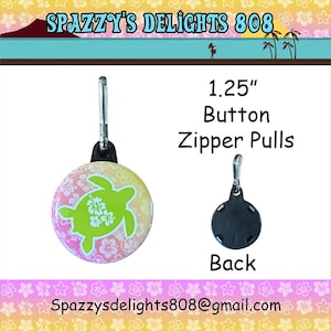 May include: A 1.25 inch round button zipper pull featuring a lime green sea turtle graphic with white hibiscus flowers on a pink and yellow gradient background, shown with a black plastic back and a silver metal lobster clasp attachment.