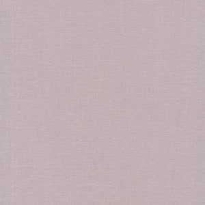 May include: A close-up of a solid, light mauve fabric with a subtle woven texture. The fabric has a slightly matte finish and appears to be a medium weight material, suitable for various sewing projects. The color is a muted, dusty rose.