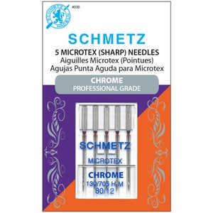 May include: A package of Schmetz Microtex sharp needles. The package is white, purple, and orange, with the brand name and needle specifications printed on the front. The needles are chrome and are labeled 130/705 H-M 80/12.