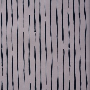 May include: A close-up of a fabric with a vertical striped pattern. The stripes are black and the background is a light beige color.