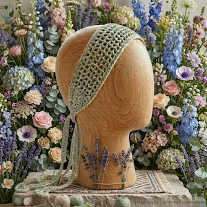 May include: A sage green crochet headband with an openwork mesh pattern and long ties, displayed on a wooden mannequin head. The headband features a delicate, lightweight construction with a consistent grid-like texture throughout the entire piece.