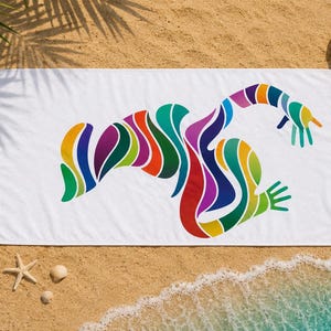 May include: A rectangular white beach towel featuring a large, central abstract graphic composed of flowing, multi-colored curved stripes in shades of red, orange, yellow, green, blue, and purple, forming a dynamic, organic, lizard-like shape.