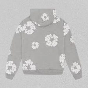 May include: A grey hoodie adorned with white floral designs. The hoodie has a drawstring hood and long sleeves. The white floral patterns are spread across the front, back, and sleeves of the garment.
