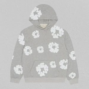 May include: A grey hoodie with white floral patterns. The hoodie has a hood, a front pocket, and ribbed cuffs and hem. White floral designs are scattered across the front, back, and sleeves.