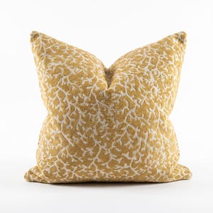 May include: A square throw pillow featuring a mustard yellow and off-white textured pattern that resembles organic coral or branching structures. The fabric has a raised, plush appearance with a consistent repeating design across the entire surface.