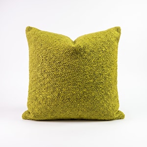 May include: A square throw pillow featuring a vibrant chartreuse green color and a highly textured, nubby surface. The fabric has a dense, raised pile construction that creates a consistent, tactile appearance across the entire front face.