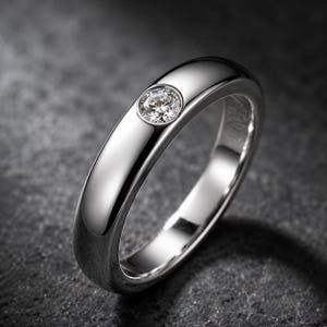 May include: A polished silver ring with a single, round, clear gemstone set in the center. The ring has a smooth, rounded band and reflects light, creating a bright, elegant appearance. The ring is a classic piece of jewelry.