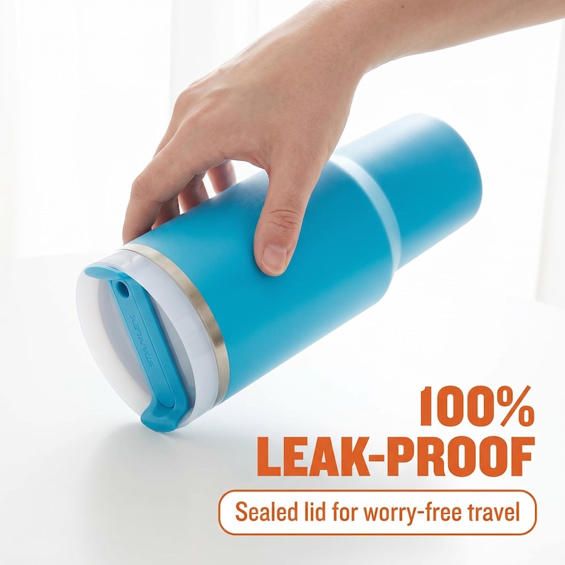May include: A blue insulated tumbler with a white and silver lid. The tumbler is held by a hand and features the text "100% LEAK-PROOF" and "Sealed lid for worry-free travel".