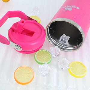 May include: A pink insulated water bottle with a matching lid and handle. The lid is open, revealing the interior. Ice cubes and lemon slices are scattered around the bottle, suggesting a refreshing drink.