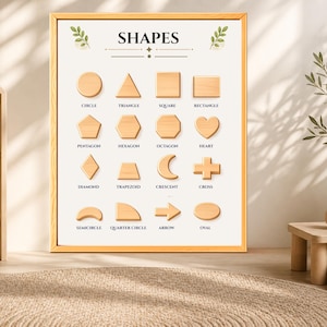 May include: A framed educational wall poster titled SHAPES featuring sixteen light wood-toned geometric shapes including a circle, triangle, square, rectangle, pentagon, hexagon, octagon, heart, diamond, trapezoid, crescent, cross, semicircle, quarter circle, arrow, and oval.