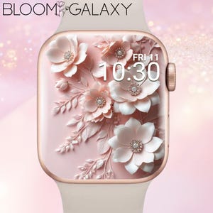 Könnte beinhalten: Roségoldene Smartwatch mit hellrosa Armband und floralem Design auf dem Bildschirm. Die Anzeige zeigt die Uhrzeit 10:30 Uhr am Freitag an. Der Text "BLOOM GALAXY" ist oben zu sehen.
