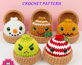 May include: Five crocheted dumpling figures in brown yarn baskets. The text reads CHRISTMAS DUMPLINGS CROCHET PATTERN and NO SEW. The figures include a white snowman, a brown gingerbread style, a yellow one, a green one, and a red and white striped one.