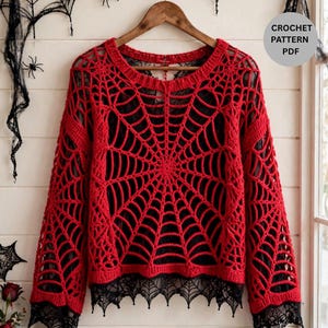 May include: A red crochet sweater featuring a spiderweb pattern throughout the body and long sleeves, with a black lace trim along the bottom hem and cuffs. The garment is displayed on a wooden hanger and includes the text CROCHET PATTERN PDF.