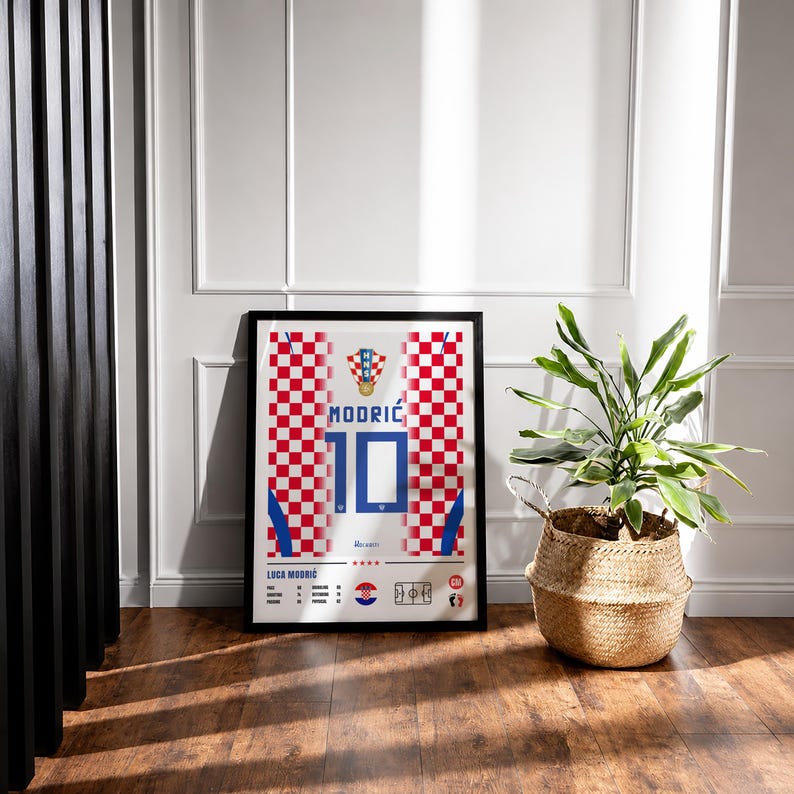 May include: A framed rectangular poster featuring a red and white checkered pattern inspired by the Croatian national soccer jersey. The design displays the name MODRIĆ, the number 10, the HNS crest, and player statistics in blue and black text.