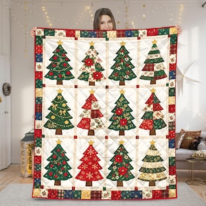 May include: A rectangular quilt featuring a grid of twelve distinct Christmas tree illustrations on a cream background. Each tree has a gold star topper and unique patterns including red ornaments, poinsettias, plaid, and gold snowflakes.
