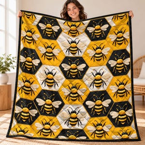 May include: A quilt featuring a repeating honeycomb pattern in alternating black and yellow hexagons. Each hexagon contains a detailed, embroidered-style graphic of a bumblebee with black and yellow stripes and white wings.