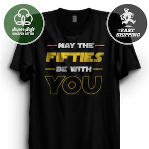 May include: Black t-shirt with a yellow graphic that says "May the Fifties Be With You".