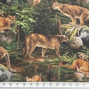 May include: Cougar-themed fabric featuring multiple cougars in a forest setting. The cougars are depicted in shades of brown and tan, amidst green foliage, rocks, and tree trunks. The fabric design evokes a sense of the wild.