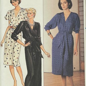 May include: A sewing pattern featuring three different dress designs. The first dress is a white and red patterned dress with short sleeves and a V-neck. The second dress is a black dress with long sleeves and a V-neck. The third dress is a blue dress with long sleeves and a V-neck. The pattern includes instructions for making each dress.