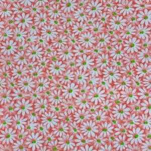 May include: A red fabric with a white daisy pattern. The daisies have green centers.