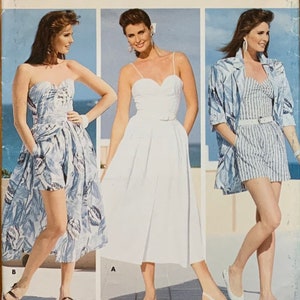 May include: Three women modeling different summer outfits. The woman on the left is wearing a strapless white and blue floral dress. The woman in the middle is wearing a white sleeveless dress with a belt. The woman on the right is wearing a blue and white striped top and shorts with a matching jacket.