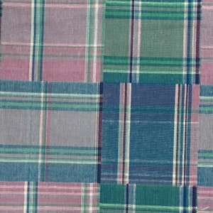 May include: A patchwork fabric with a plaid pattern in shades of pink, blue, and green.