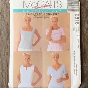 May include: A sewing pattern for a women's top with a full bust. The pattern includes four different styles: a sleeveless top with a square neckline, a sleeveless top with a V-neckline, a short-sleeved top with a square neckline, and a short-sleeved top with a V-neckline. The pattern is for sizes 10-12-14.