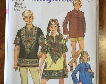 May include: A vintage Simplicity sewing pattern for three garments. The pattern is for a tunic, a shirt, and a dress. The pattern is for size 8, bust 31 1/2 inches, and is for misses. The pattern is from the 1970s and features a retro style.