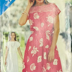 May include: A red dress with white seashell patterns and a striped neckline. The dress features short sleeves and a fitted waist. A smaller image shows a white dress with a drawstring waist. The dress is a size A.