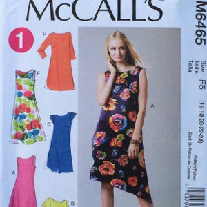 May include: A sewing pattern for a dress with five different styles. The pattern is for sizes 16-18-20-22-24. The pattern is called McCall's M6465.