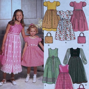 May include: A sewing pattern showing designs for girls' dresses. The dresses include a pink gingham dress, a floral print dress, and a yellow dress with a floral overlay. Matching purses are also shown.