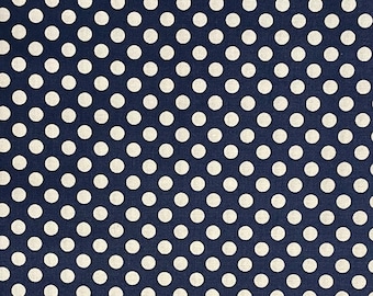 May include: A navy blue fabric with a white polka dot pattern. The dots are evenly spaced and create a classic and timeless design.
