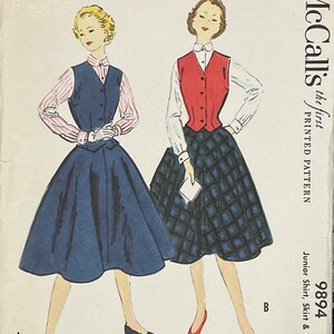 May include: Vintage McCall's sewing pattern for a junior shirt, skirt, and vest. The pattern is for a two-piece outfit with a red vest and a plaid skirt, and a separate shirt and skirt outfit with a blue vest and a solid blue skirt. The pattern number is 9894.