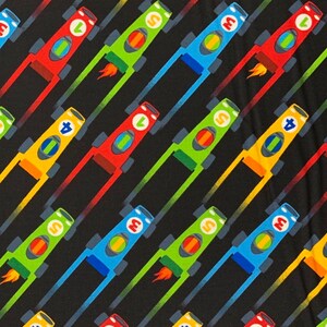 May include: A black background with a repeating pattern of colorful race cars. The cars are red, yellow, green, and blue. Each car has a number on it. The numbers are 3, 0, 5, 1, 4, 6, 10, S, U, and 0.
