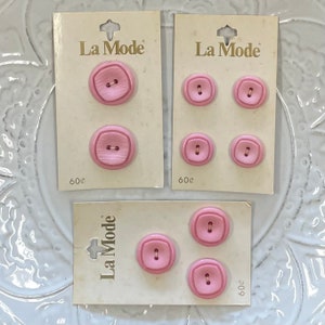 May include: Three cards with pink buttons on them. Each card has the text "La Mode" and a price of 60c. The buttons are different sizes and shapes.