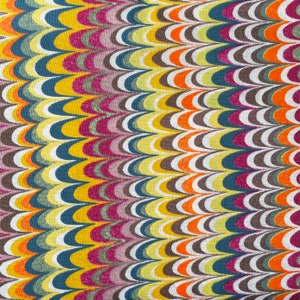 May include: A fabric with a repeating pattern of curved lines in shades of yellow, orange, red, white, blue, and brown. The pattern resembles a wave or a series of overlapping arcs.