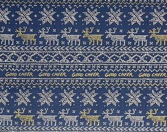 May include: A navy blue fabric with a white and gold snowflake and reindeer pattern. The fabric has the text "GOOD CHEER" repeated across the bottom.