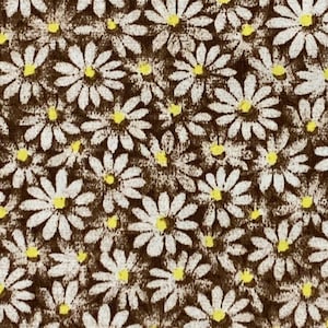 May include: A brown fabric with a white daisy pattern. The daisies have yellow centres.