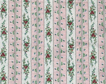 May include: White fabric with a repeating pattern of pink stripes and small green sprigs with red and blue flowers.