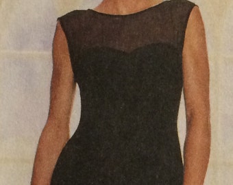 May include: A woman wearing a black sleeveless dress with a sheer overlay at the neckline. The dress has a fitted bodice and a flowing skirt.