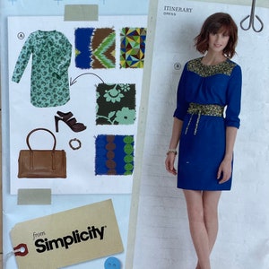 May include: A blue dress with a yellow and green patterned yoke and a matching belt. The dress is shown with different fabric options for the yoke and belt.